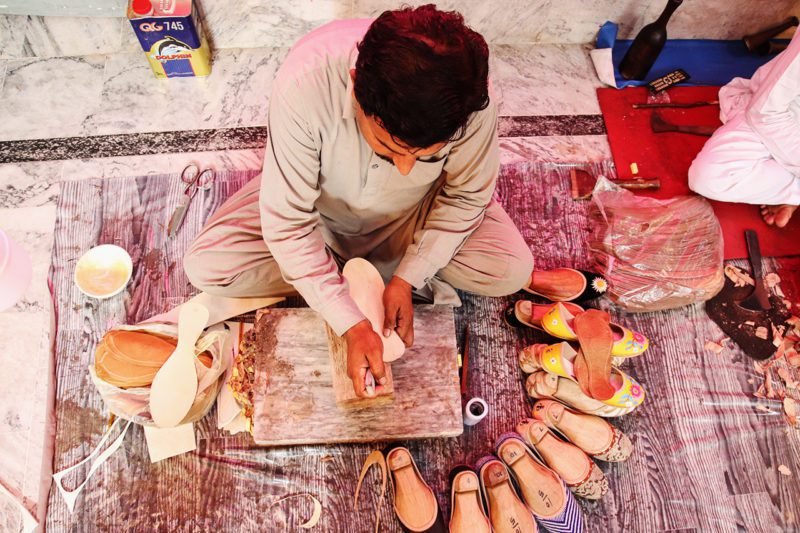 Pakistani artisan man making shoes