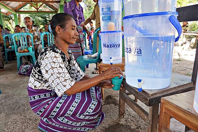 Woman using Nazava water filter