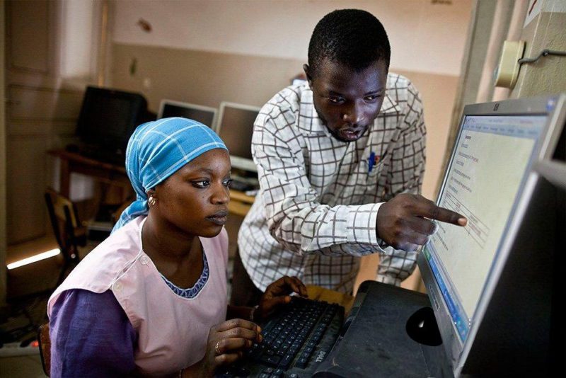 African man and woman at computer