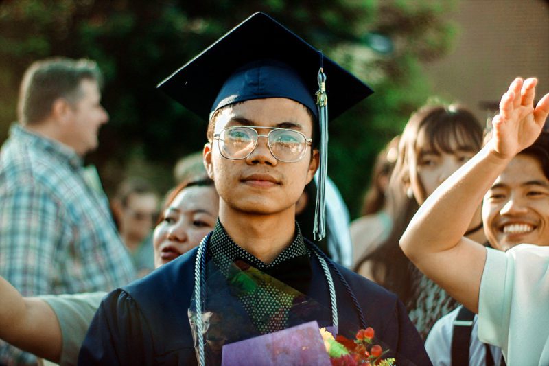 Asian student in cap and gown