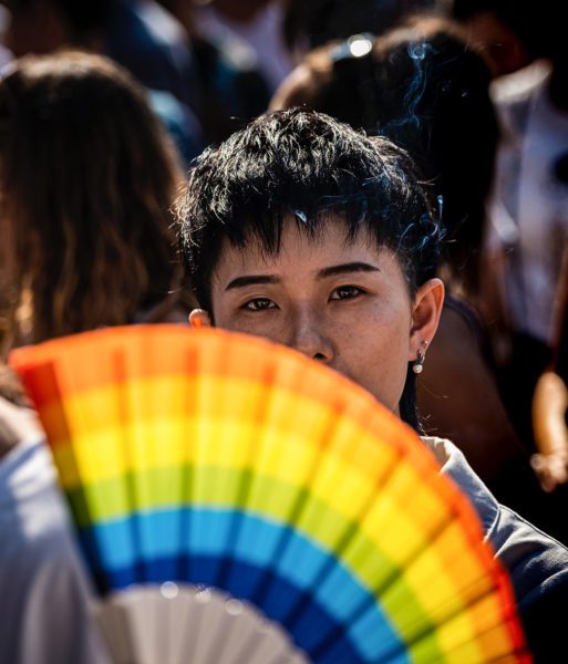 Woman behind rainbow fan at pride march