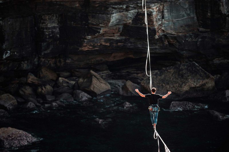 Man scaling cliff