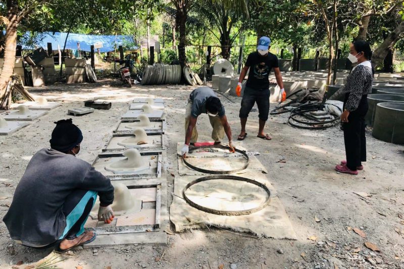 Cambodian workers installing latrines