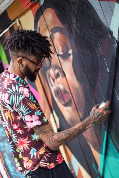 Male artist painting mural