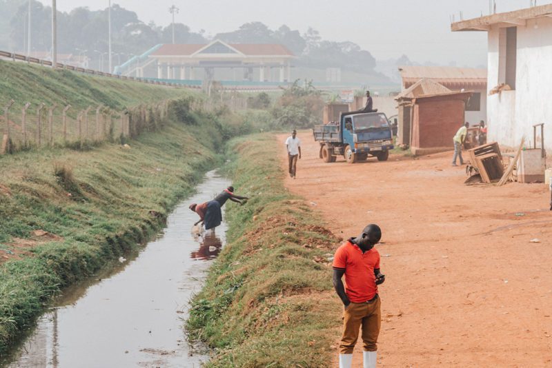 Africans and truck next to canal