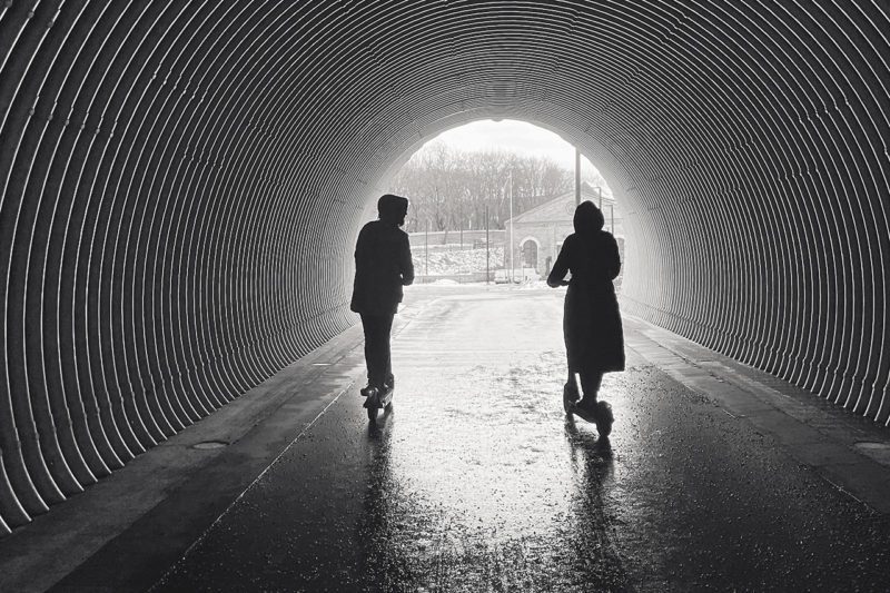 Two figures in a tunnel