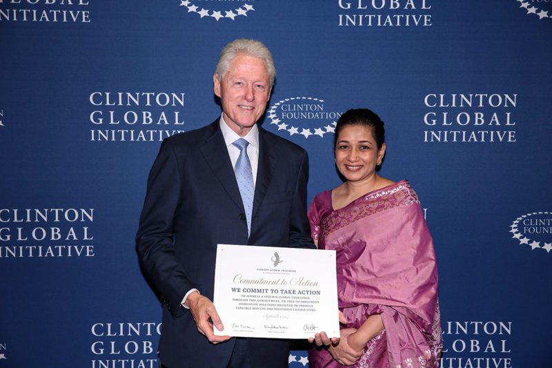 The author with President Bill Clinton announcing the creation of the Women's Livelihood Bond at Clinton Global Initiative.