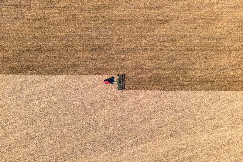 Tractor harvesting field from above