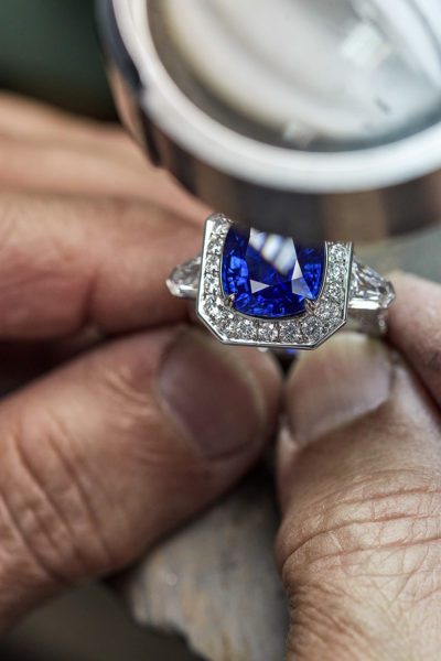 Hands crafting a sapphire ring