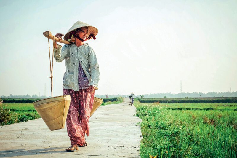 Asian woman carrying basket