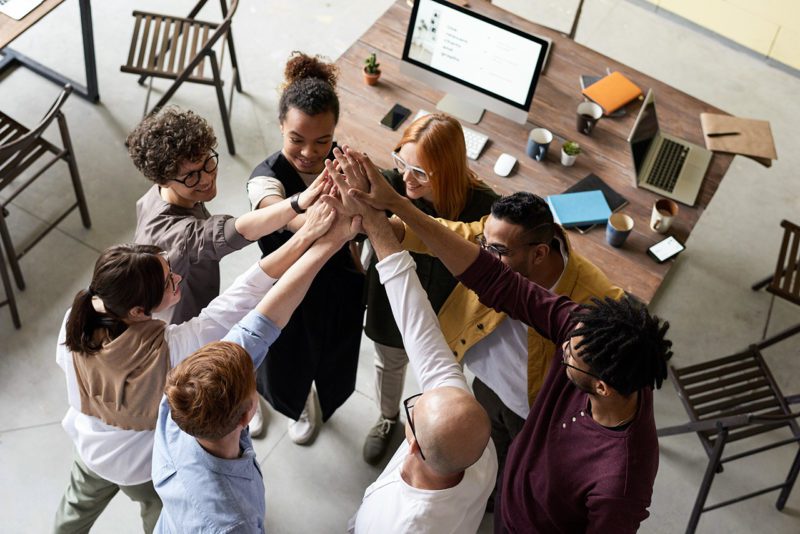 Group of diverse entrepreneurs with raised and joined  hands