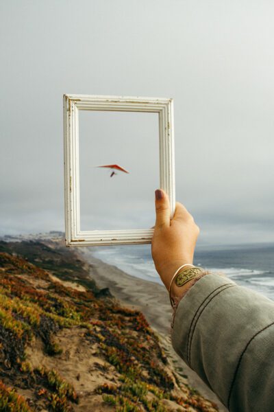 Hand holding frame to sky