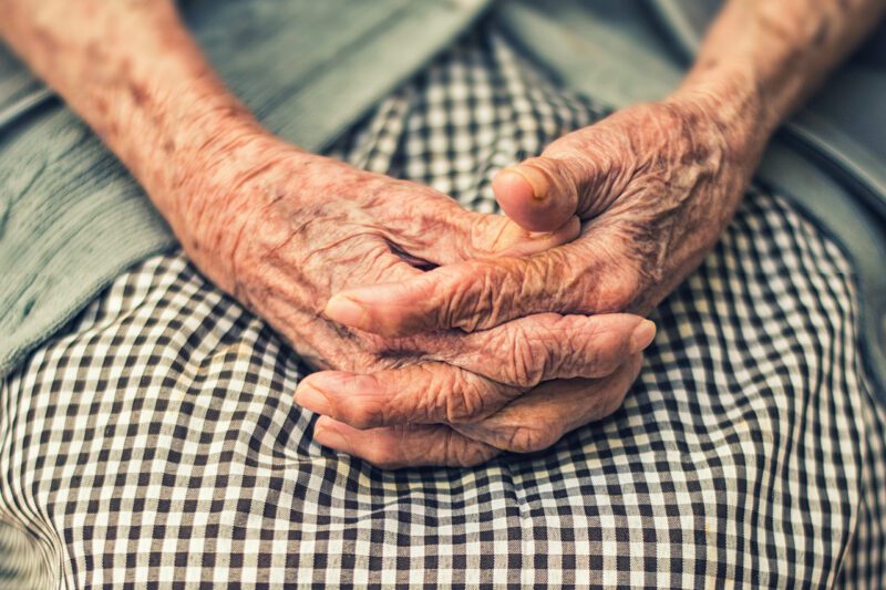 Elderly woman's hands on her lap