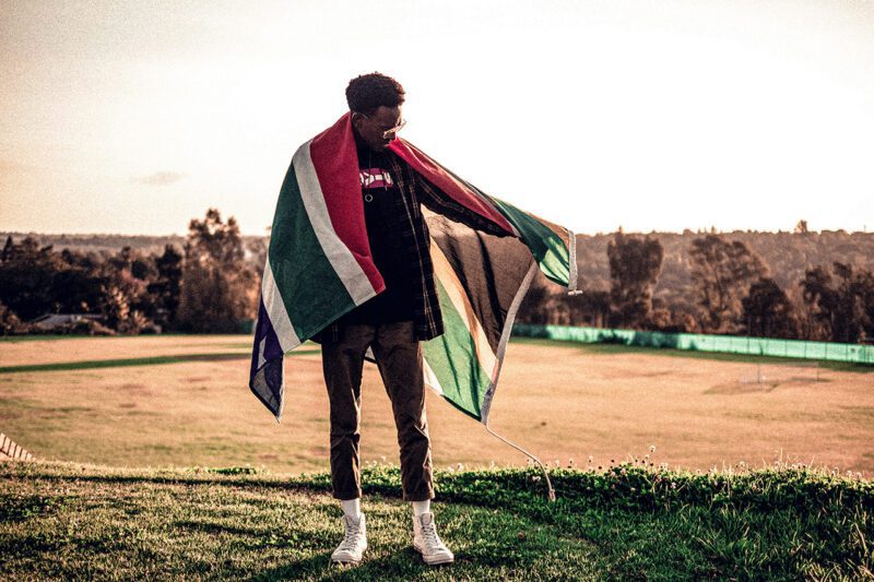 African man draped in South African flag