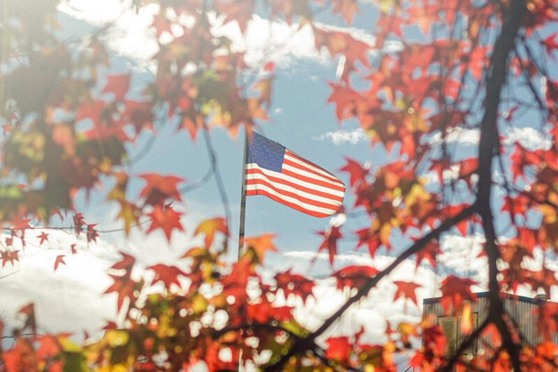 US flag through autumn colors