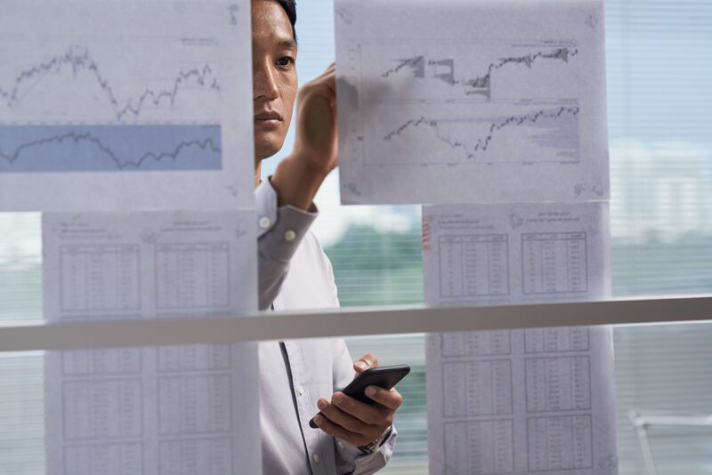 Male professional with sheets of paper on wall
