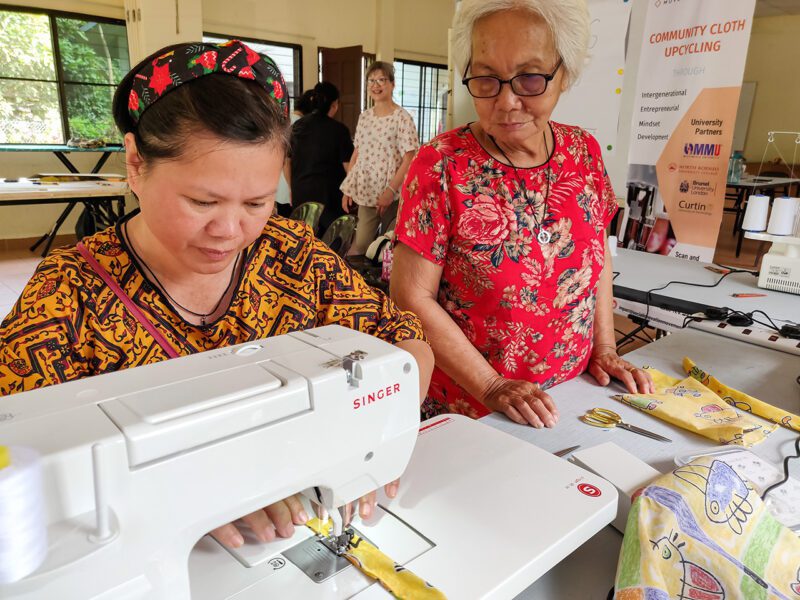 Two Asian women at sowing machine