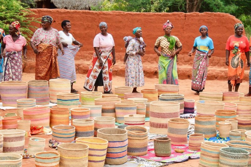 African women basket weavers with product