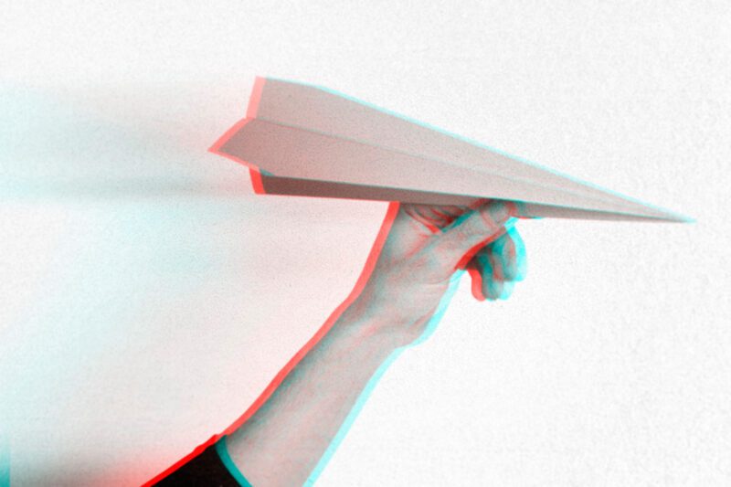 Hand holding paper airplaine