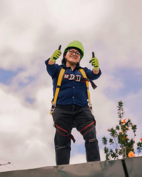 Woman solar installer giving thumbs up